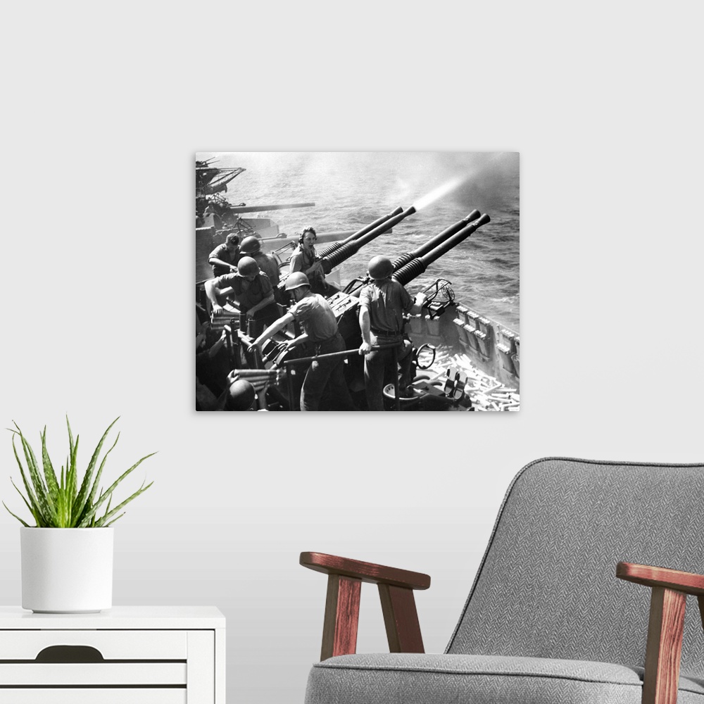 A modern room featuring Crew members on board a U.S. Navy aircraft carrier fire anti-aircraft guns at Japanese planes in ...