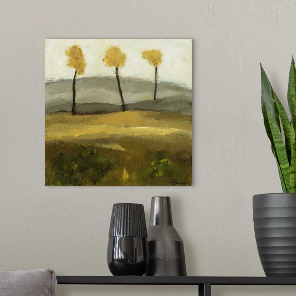 A modern room featuring Contemporary landscape painting with three trees in autumn foliage standing together in the dista...