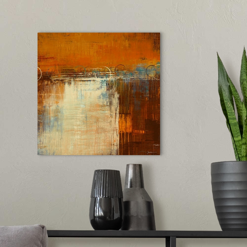 A modern room featuring Square, abstract painting in warm earth tones of patchy, layered colors with small drips running ...