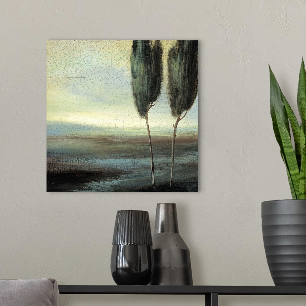 A modern room featuring Contemporary painting of two trees standing in an empty looking field.