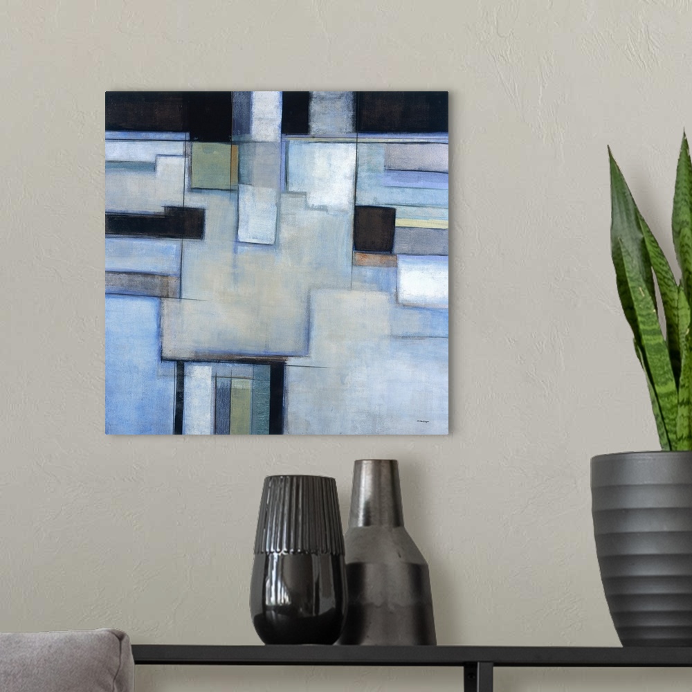 A modern room featuring A square abstract painting with square shapes in shades of blue.