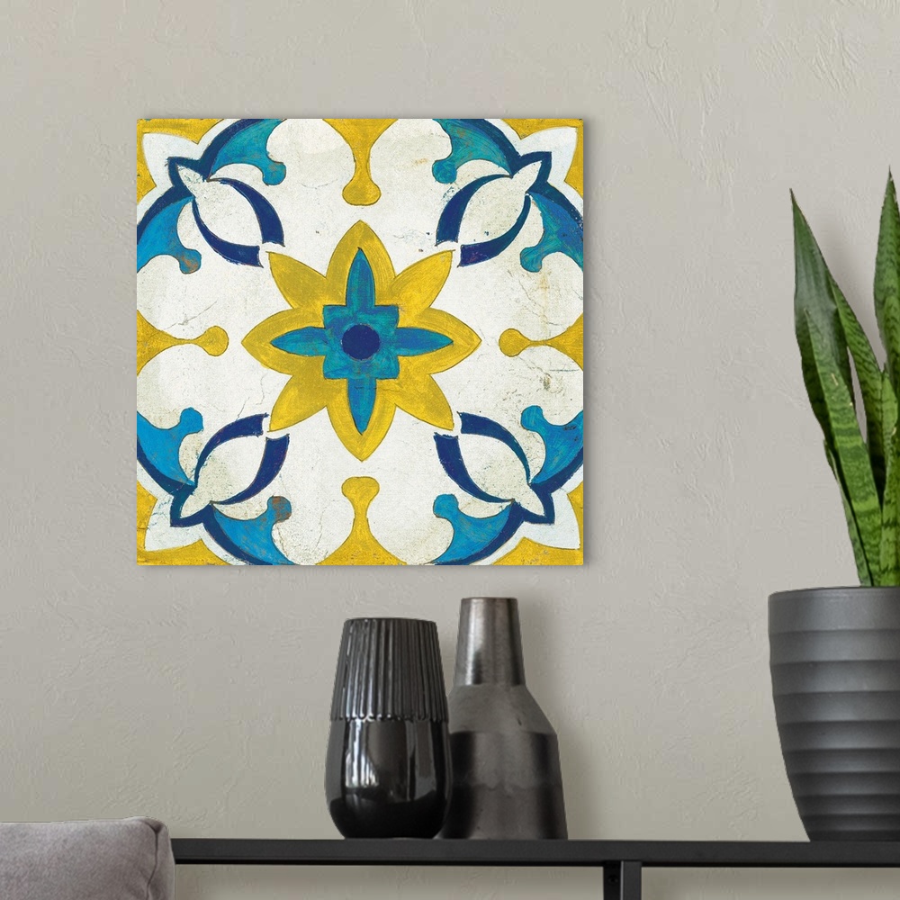 A modern room featuring Decorative square painting of a floral tile design in colors of blue, yellow and white.