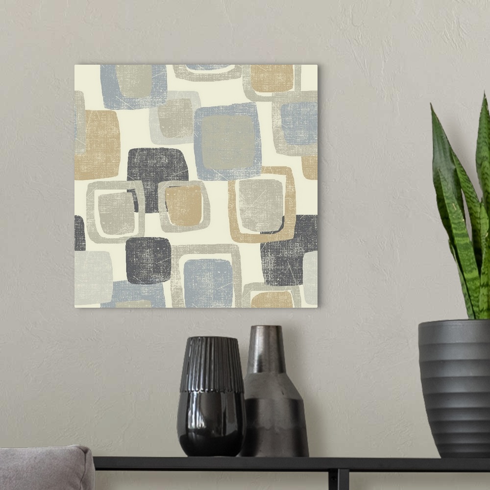 A modern room featuring Abstract artwork filled with gray, tan, and blue squares stacked on a cream colored background.