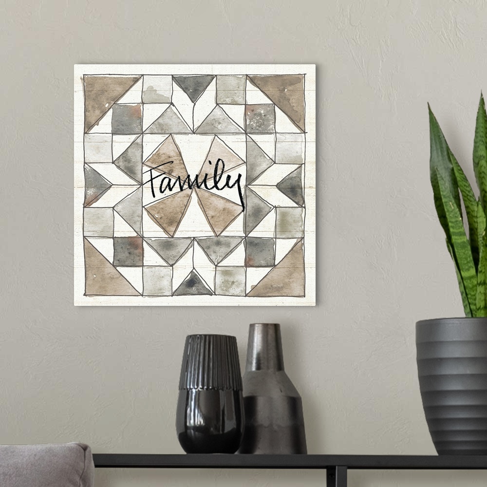 A modern room featuring "Family" with a watercolor quilt box design in neutral colors on a wood panel backdrop.