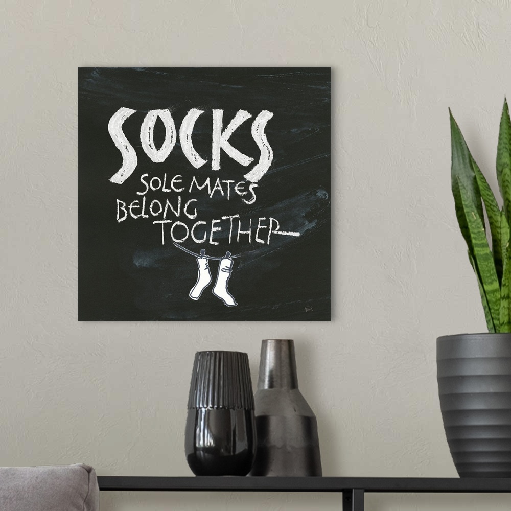 A modern room featuring "Socks, Sole Mates Belong Together" on a chalkboard backdrop.
