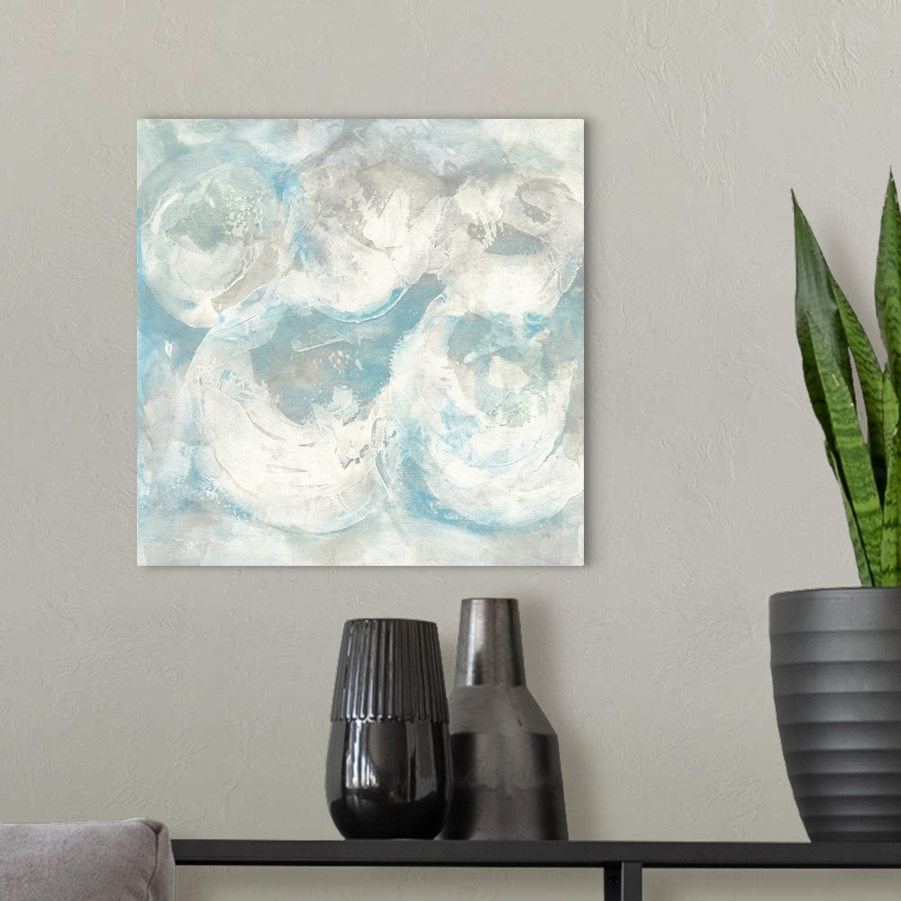 A modern room featuring Square abstract painting of textured swirls of white and blue.