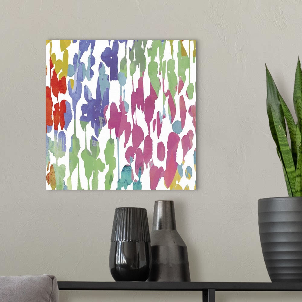 A modern room featuring Bright artwork made of varying splatters in rainbow colors.