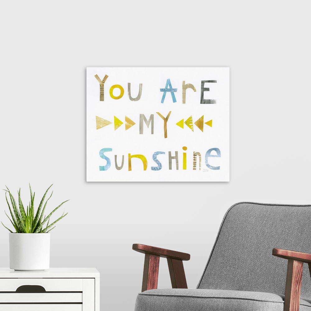 A modern room featuring Whimsy sentiment decor with the phrase "You Are My Sunshine" written in different colors.