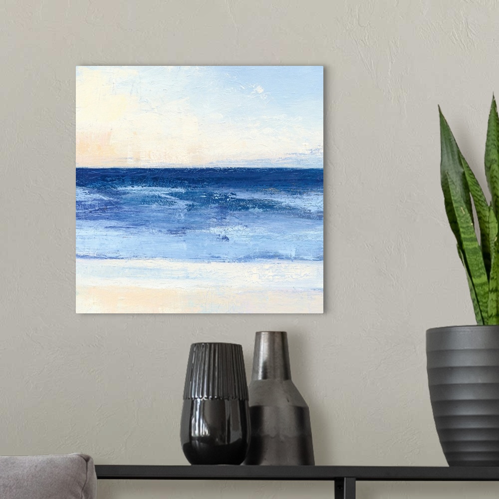 A modern room featuring Contemporary coastal themed painting of a calm sea seen from a beach shoreline.