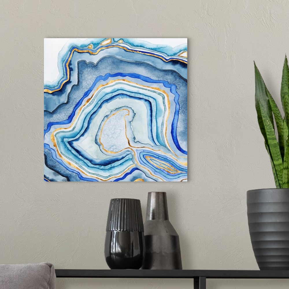 A modern room featuring Abstract artwork in blue and gold layers resembling a cross section of an agate stone.