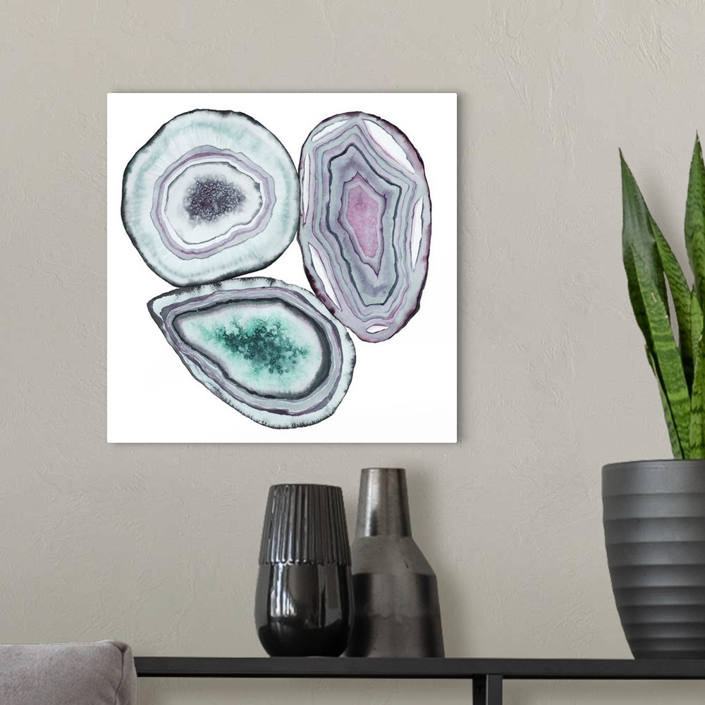 A modern room featuring Square watercolor artwork of geode rocks in green, purple and blue on a white background.