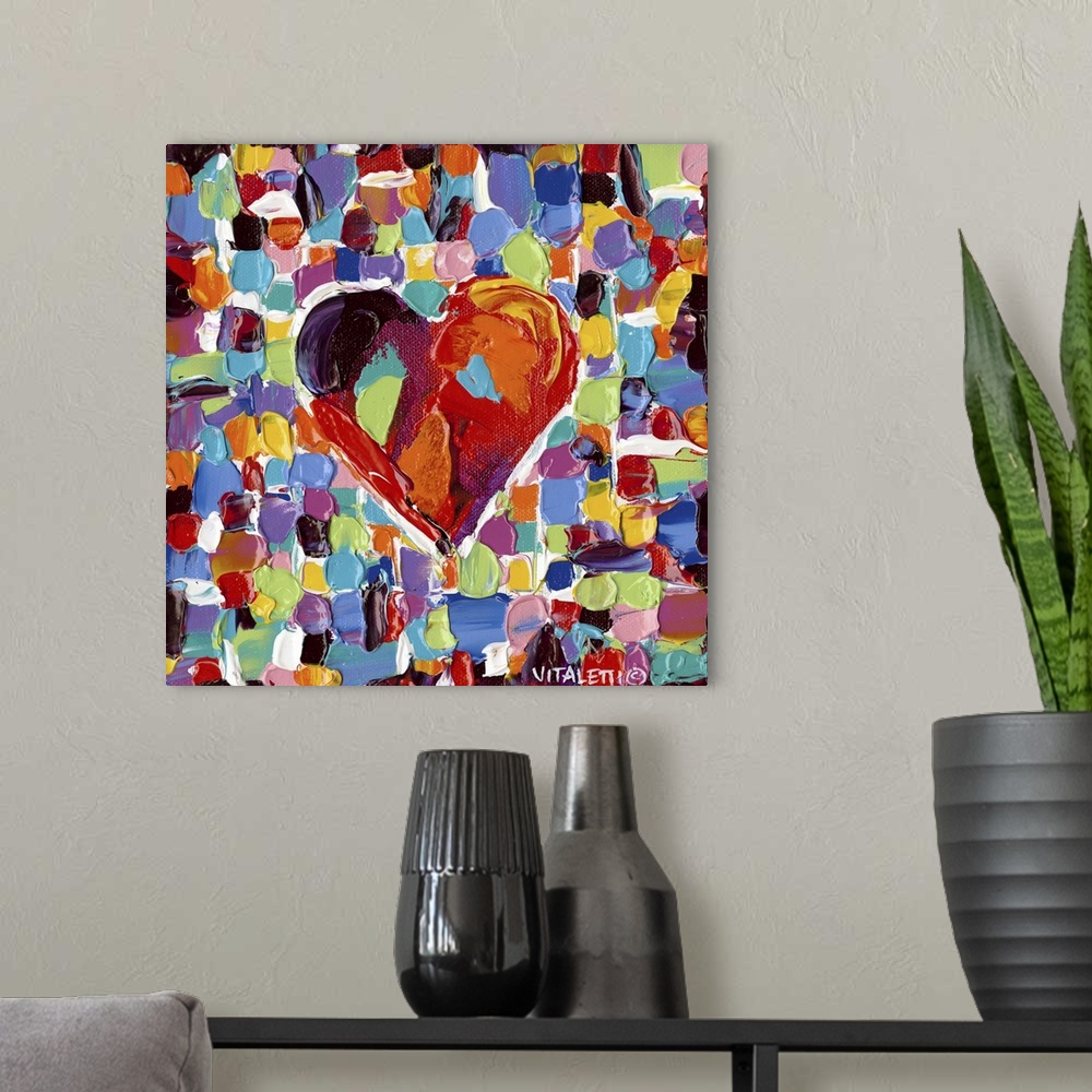A modern room featuring Artwork of a technicolor heart on tiled squares with heavy dabs of paint and vivid colors.