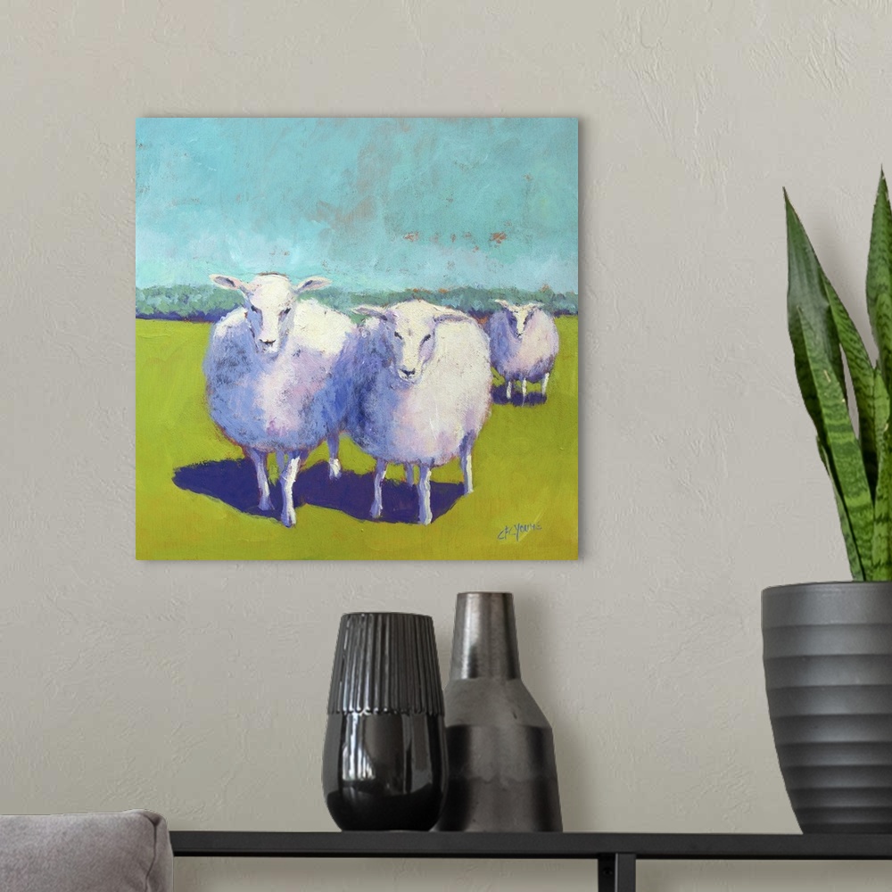 A modern room featuring Contemporary painting of three woolly sheep in a green field.