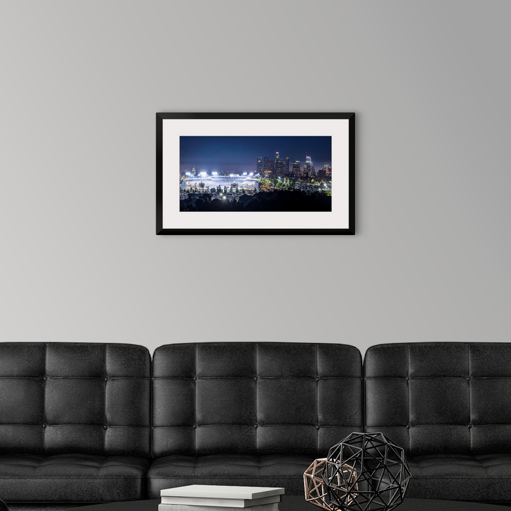 A modern room featuring Photograph of Dodger Stadium lit up on a game night with the Los Angeles skyline on the right.