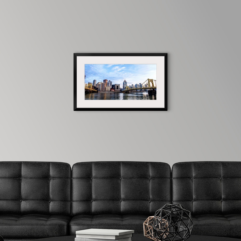 A modern room featuring Photo of downtown Pittsburgh with Roberto Clemente Bridge over the Allegheny River.