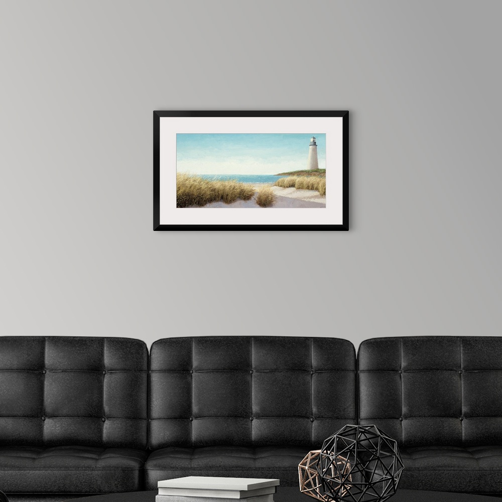 A modern room featuring Horizontal, large wall picture of grasses blowing on the beach.  A lighthouse in the distance, ne...