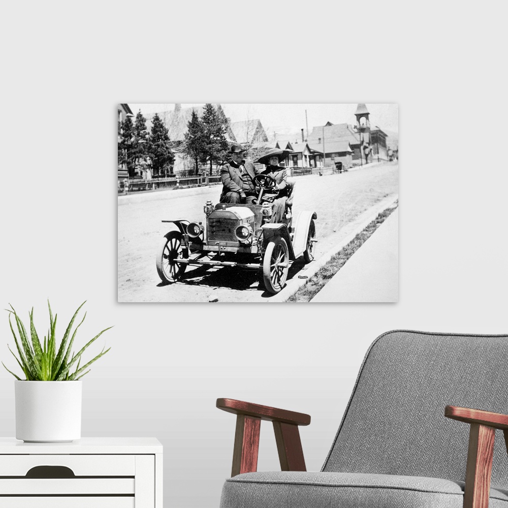 A modern room featuring Couple pose in their early Brush Motor Car Company automobile on a Colorado street in the early 2...