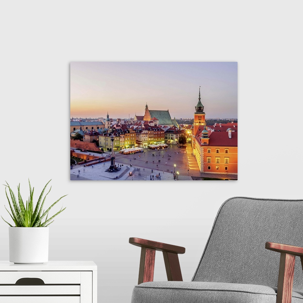 A modern room featuring Poland, Masovian Voivodeship, Warsaw, Old Town, Elevated view of the Castle Square at twilight.