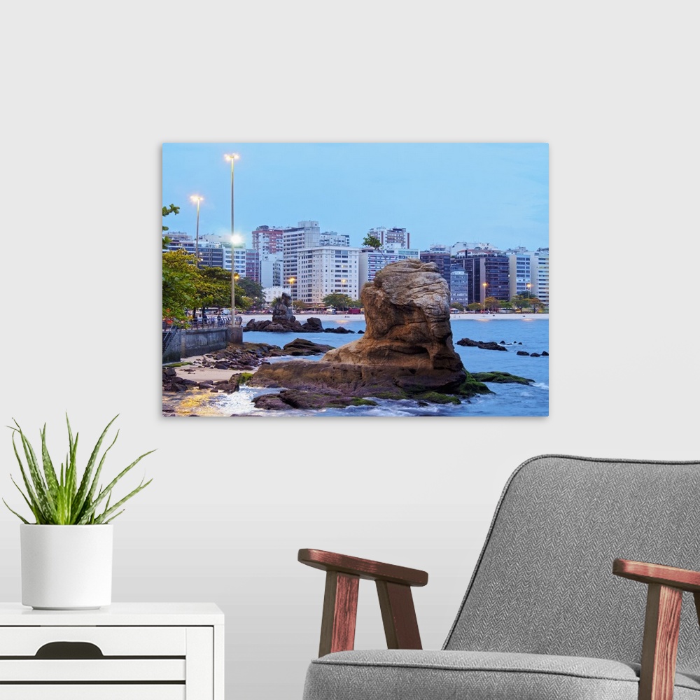 A modern room featuring Twilight view towards Icarai Beach with skyline of Niteroi, State of Rio de Janeiro, Brazil, Sout...