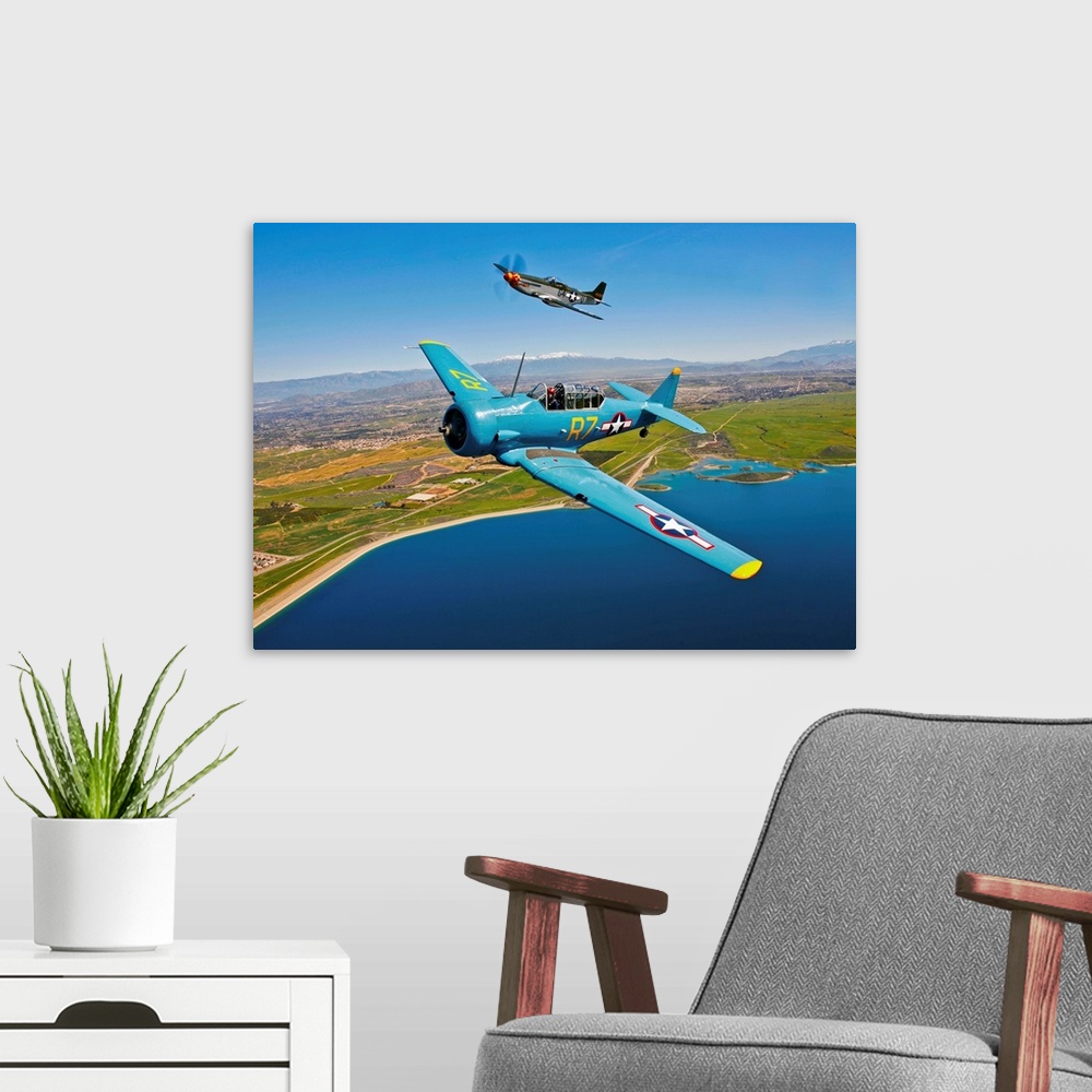 A modern room featuring A North American T-6 Texan and a P-51D Mustang in flight over Chino, California.
