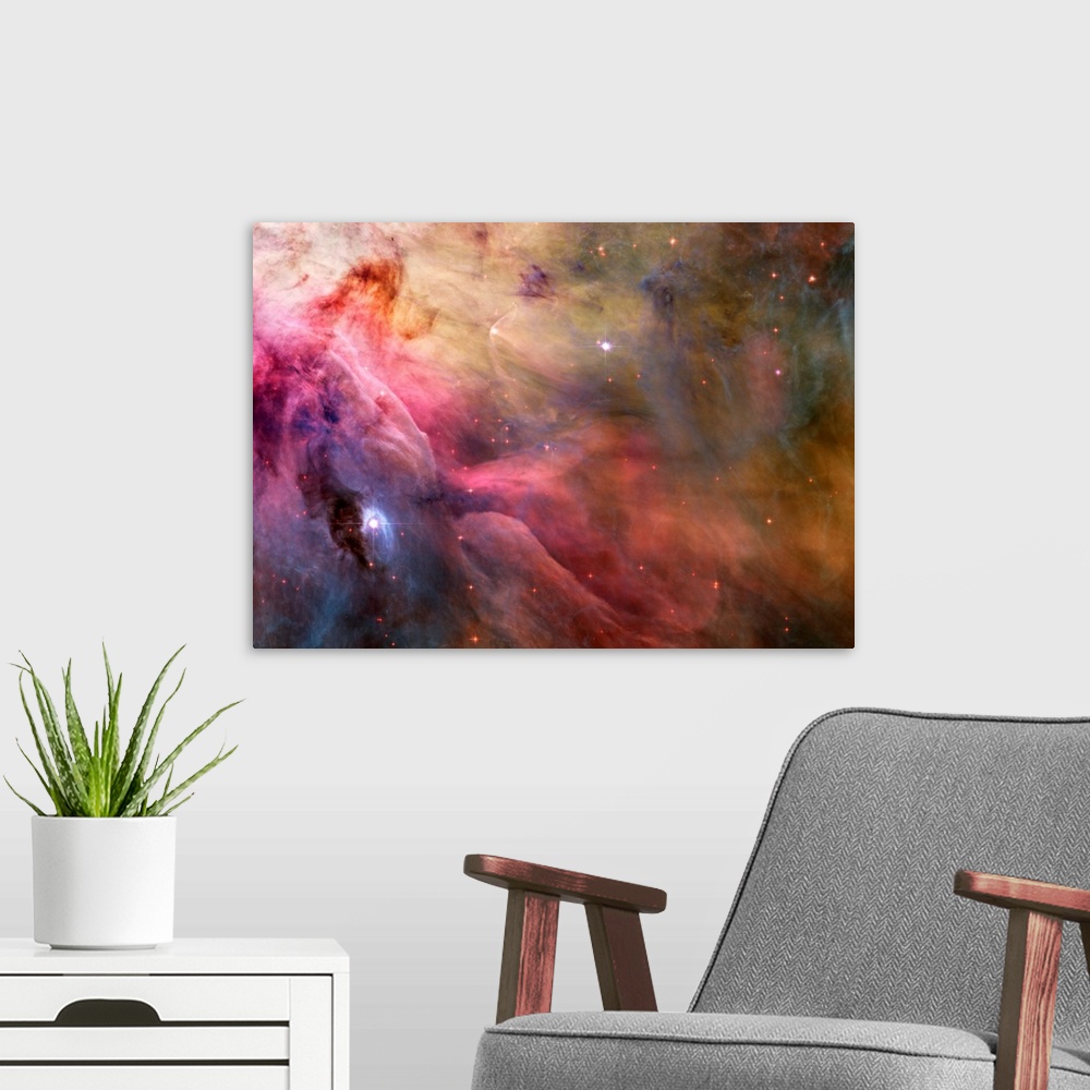 A modern room featuring Big canvas decor of a multicolored nebula with stars sprinkled around.