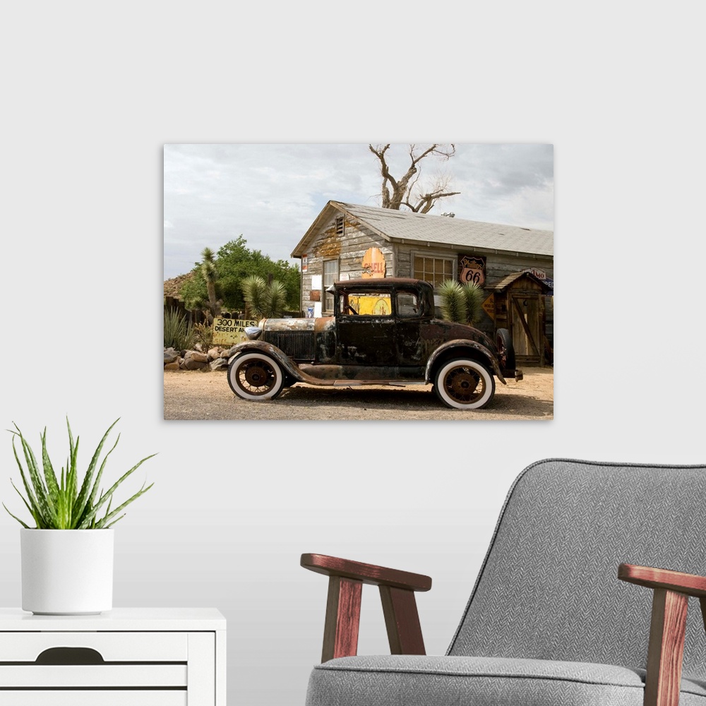 A modern room featuring An old rusted automobile in front of the Hackberry General Store along Route 66 in Hackberry, Ari...