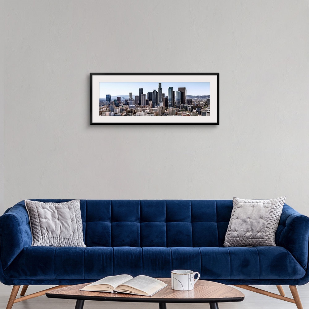 A modern room featuring Panoramic photograph of skyscrapers and surrounding buildings of the Los Angeles skyline under a ...