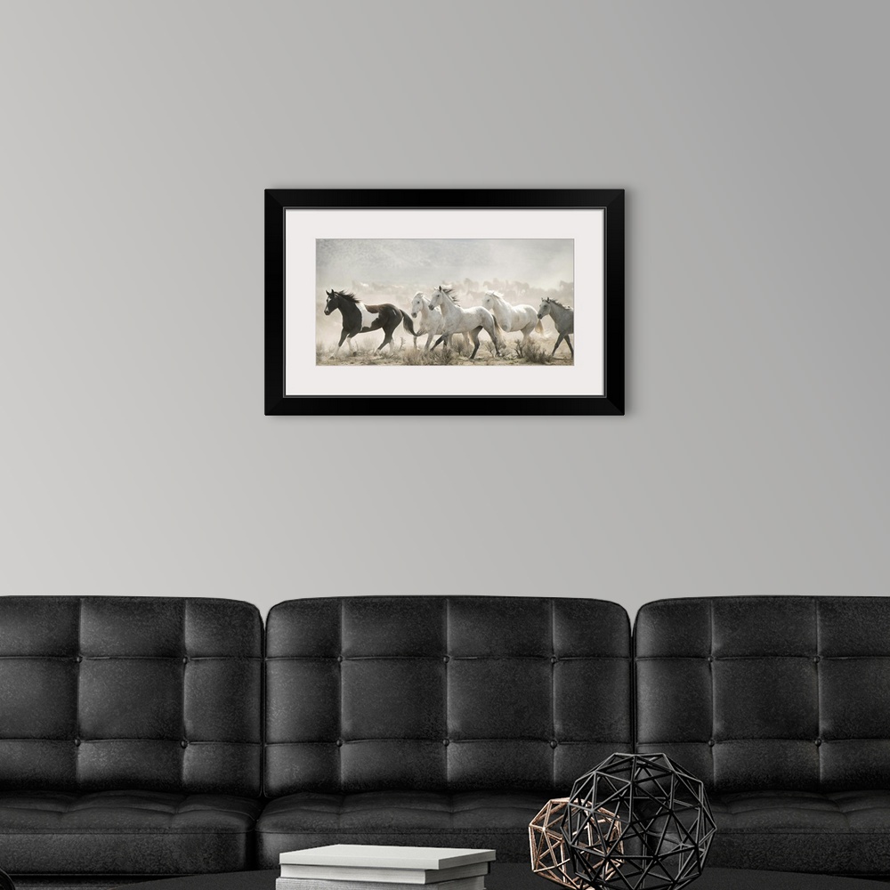 A modern room featuring Artistic photograph of wild horses running through a dry landscape kicking up dust into the air.