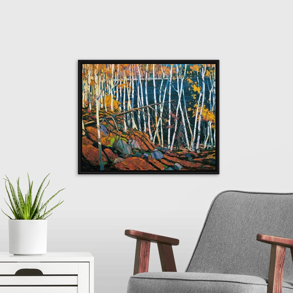 A modern room featuring A painting made on canvas of thin trees with rocks on the ground surrounding a lake.
