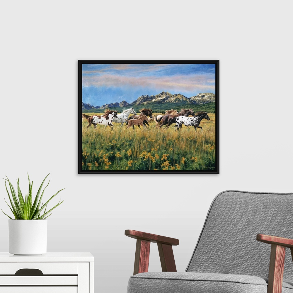 A modern room featuring Painting of wild horses running through a meadow of flowers and tall grass with mountains in the ...