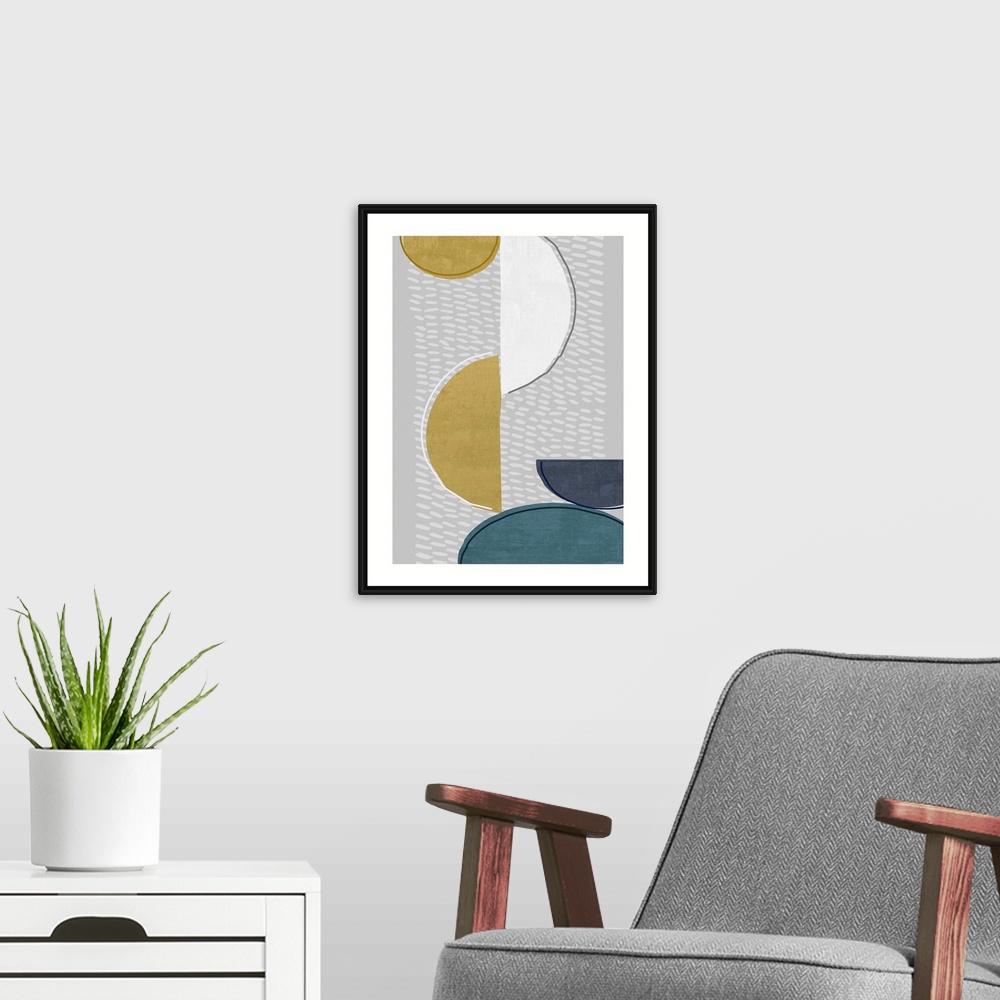 A modern room featuring Midcentury style abstract art of semi-circle shapes in blue, gold, and white on grey.