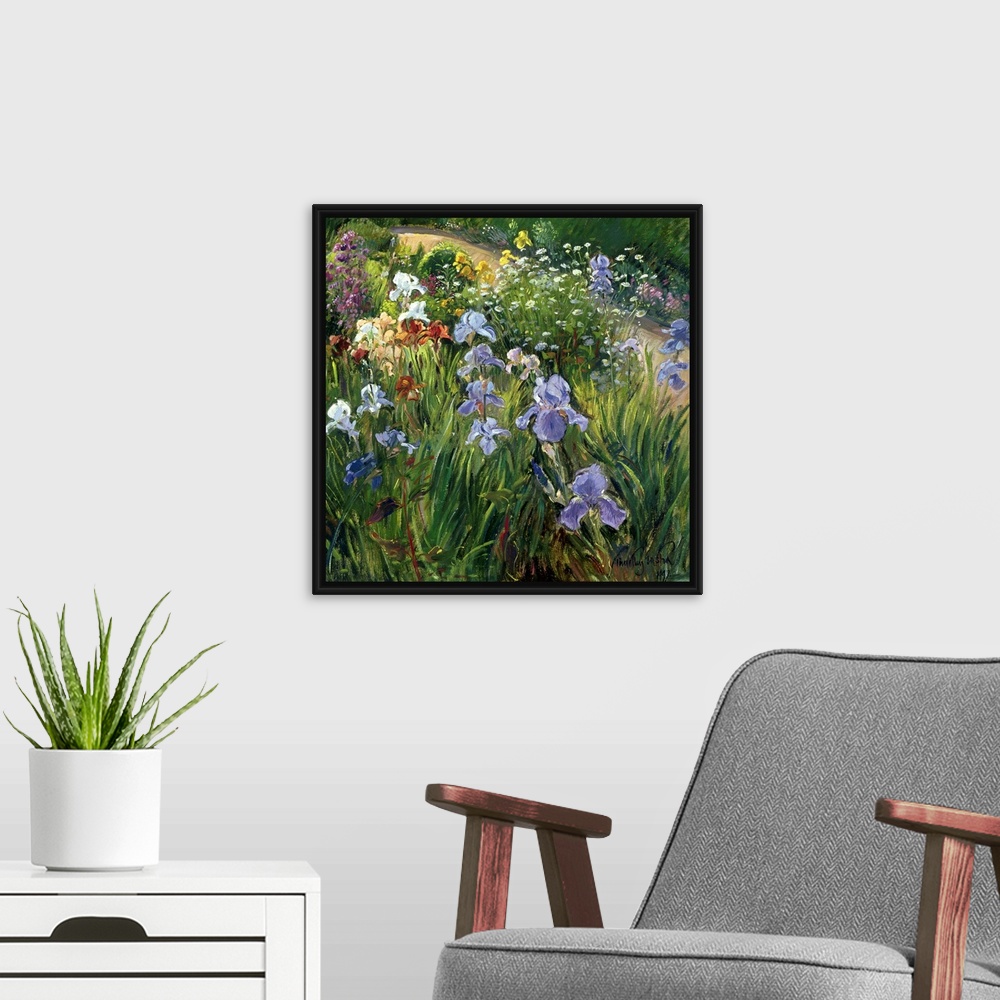 A modern room featuring Large square floral art focuses on a variety of flowers at close range that includes irises and o...