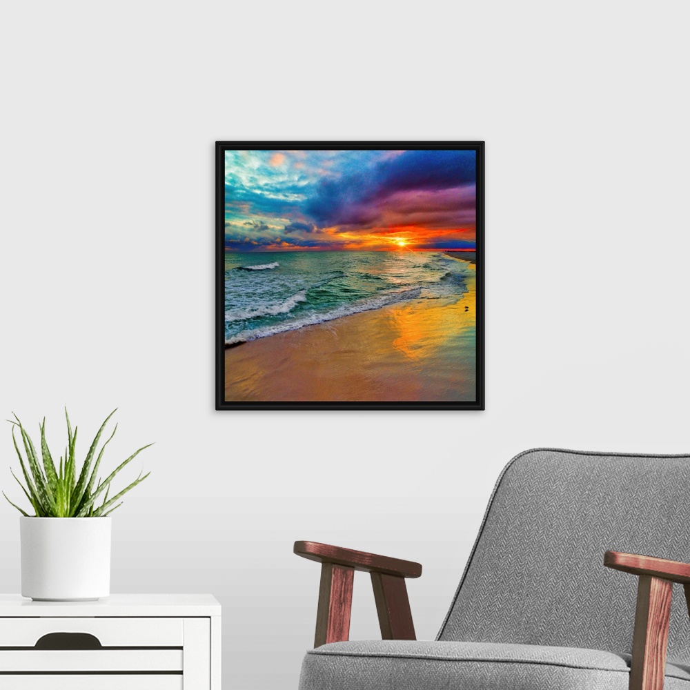 A modern room featuring A square image of the sun descending over the ocean amid bright, technicolor clouds.
