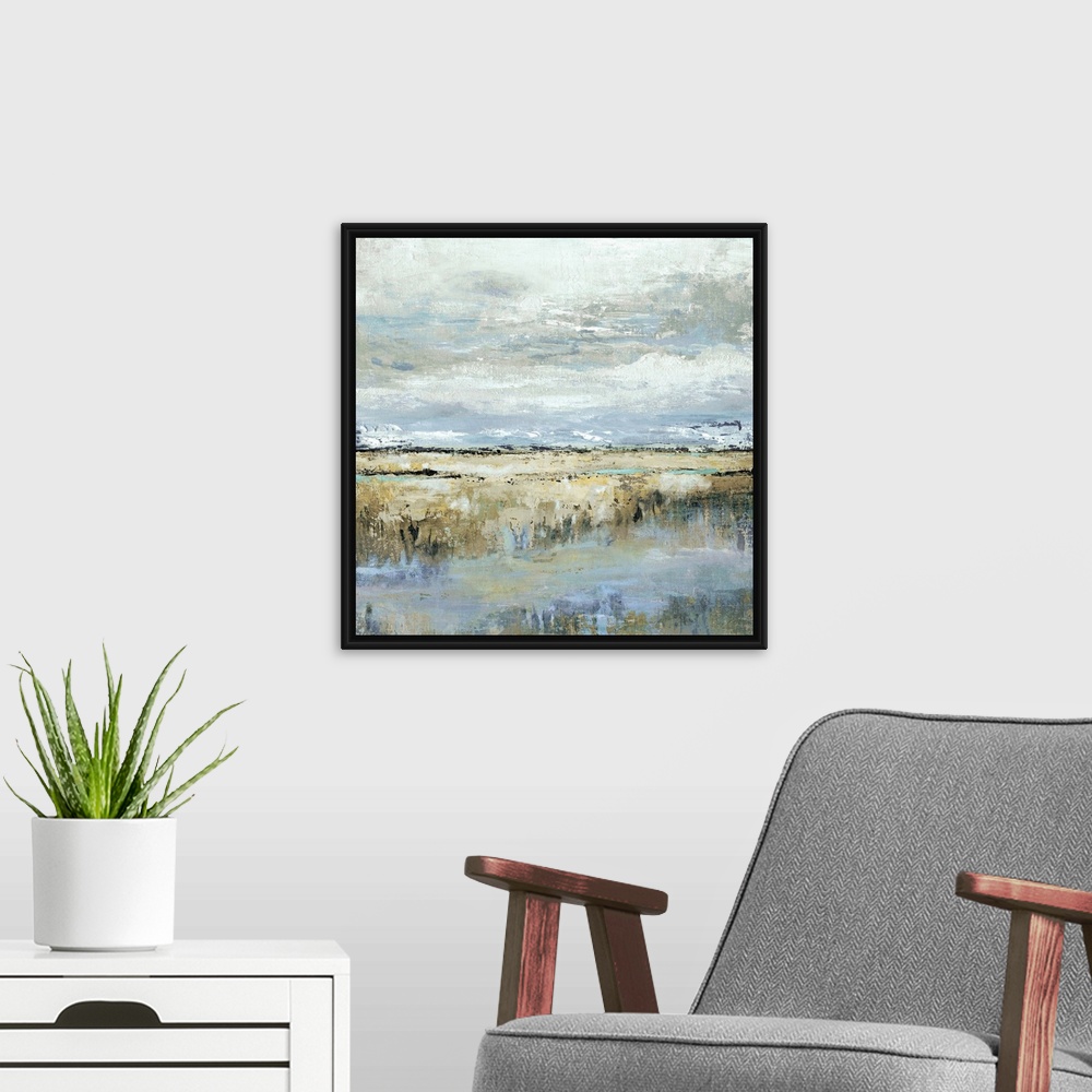 A modern room featuring Square abstract painting of a marsh landscape in shades of brown, blue, yellow, and grey.