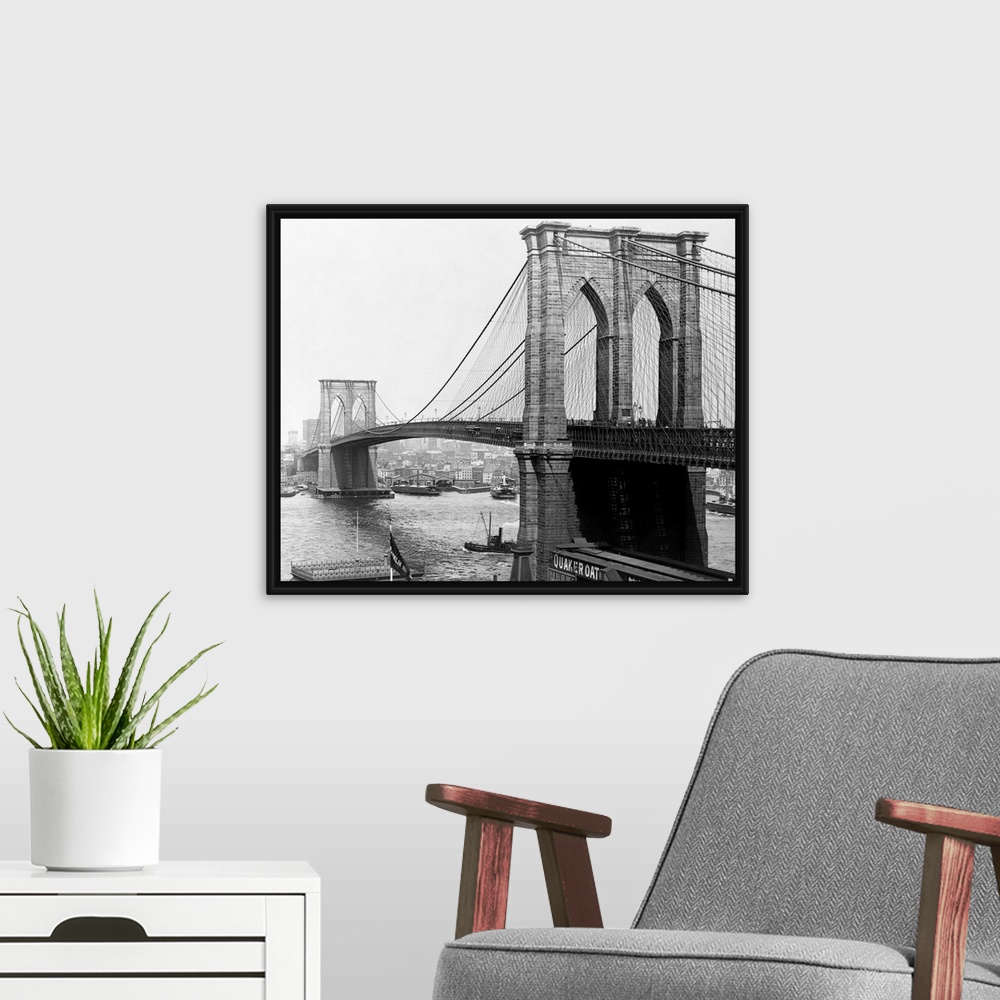 A modern room featuring A view of the Brooklyn Bridge which spans across the East River connecting Manhattan Island to Br...