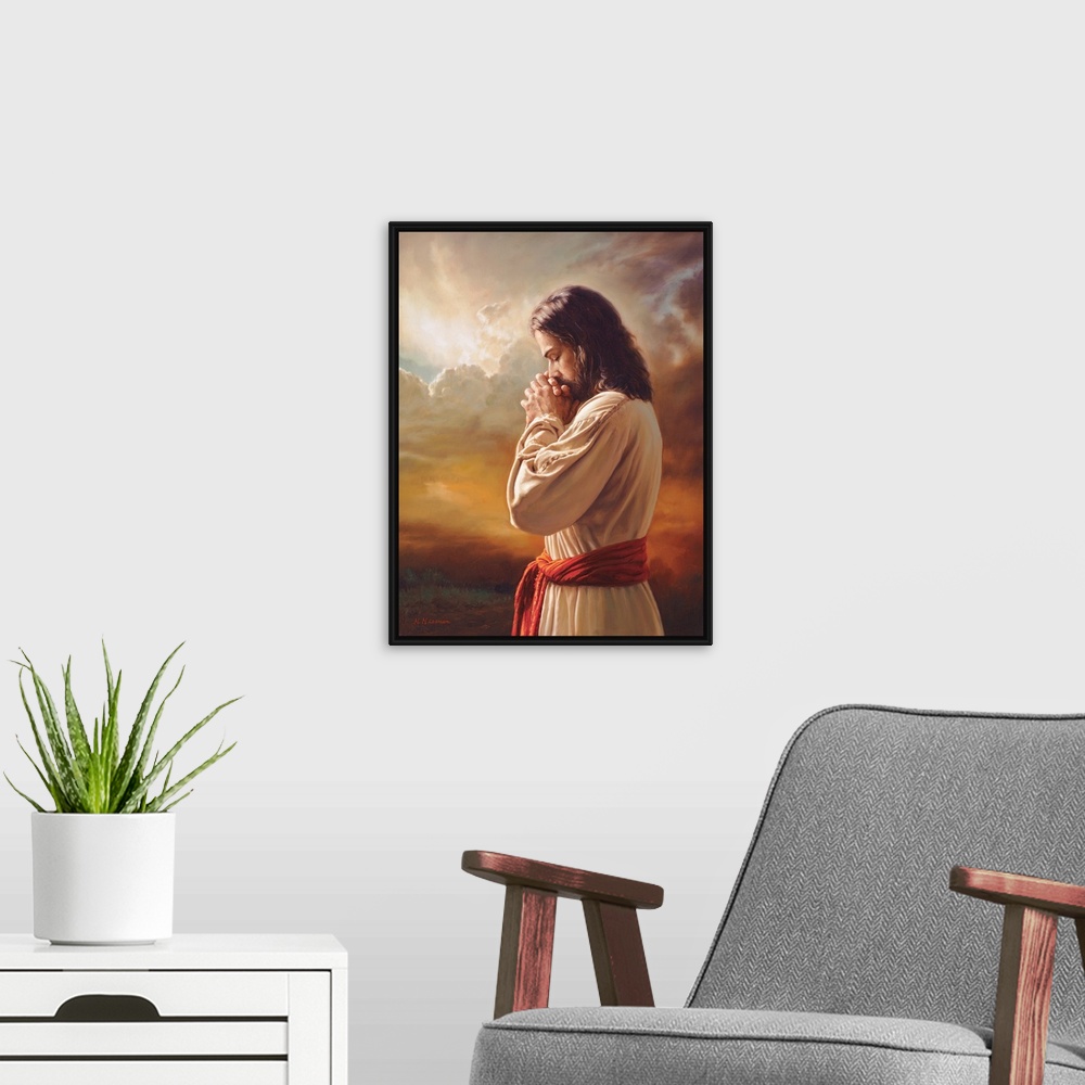 A modern room featuring Fine art painting of Jesus praying in front of a sunset while wearing a red belt.