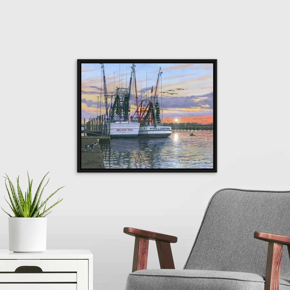 A modern room featuring Contemporary artwork of two fishing oats sitting in a harbor at sunset.