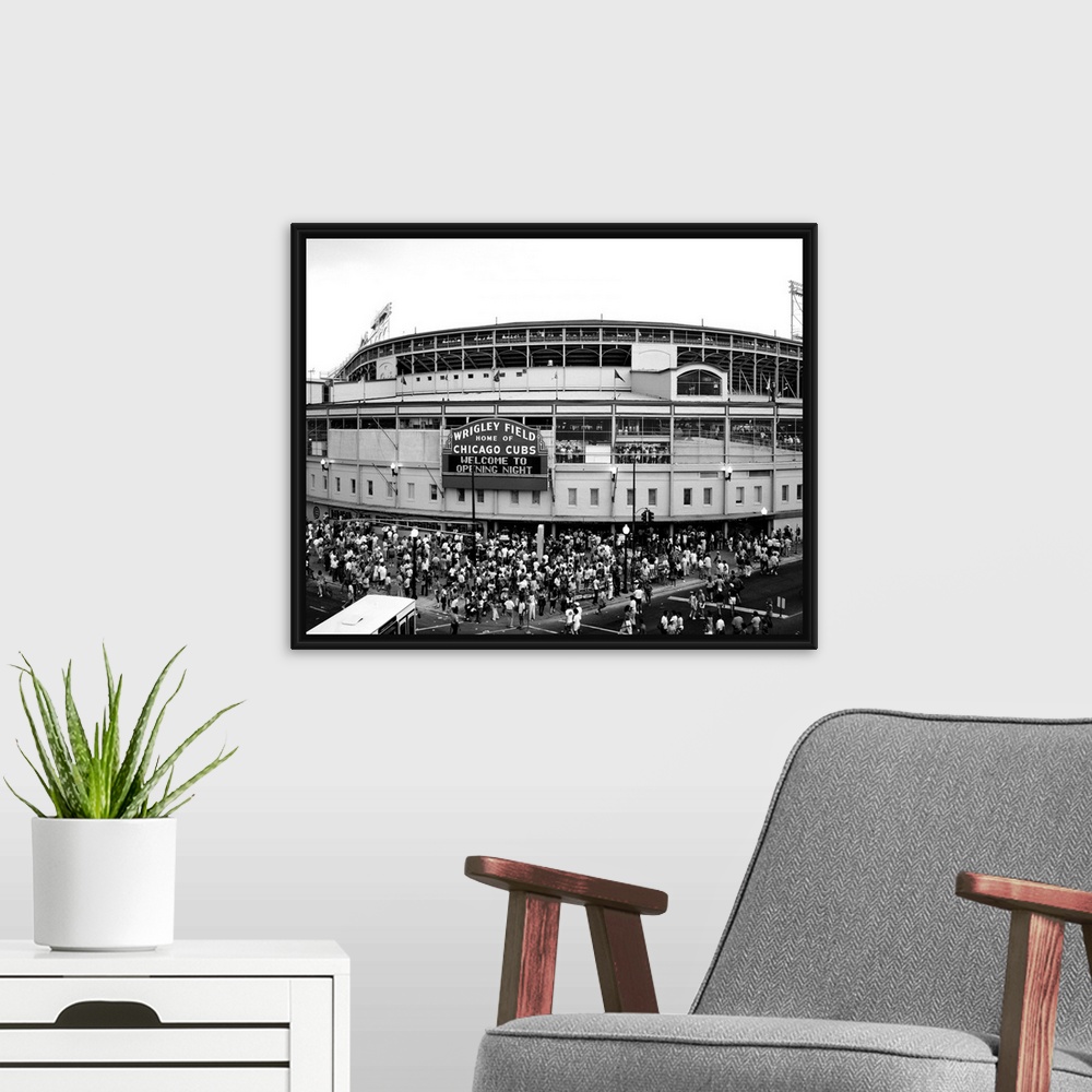 A modern room featuring A black and white photograph taken outside of the Chicago Cubs stadium as fans are shown entering...