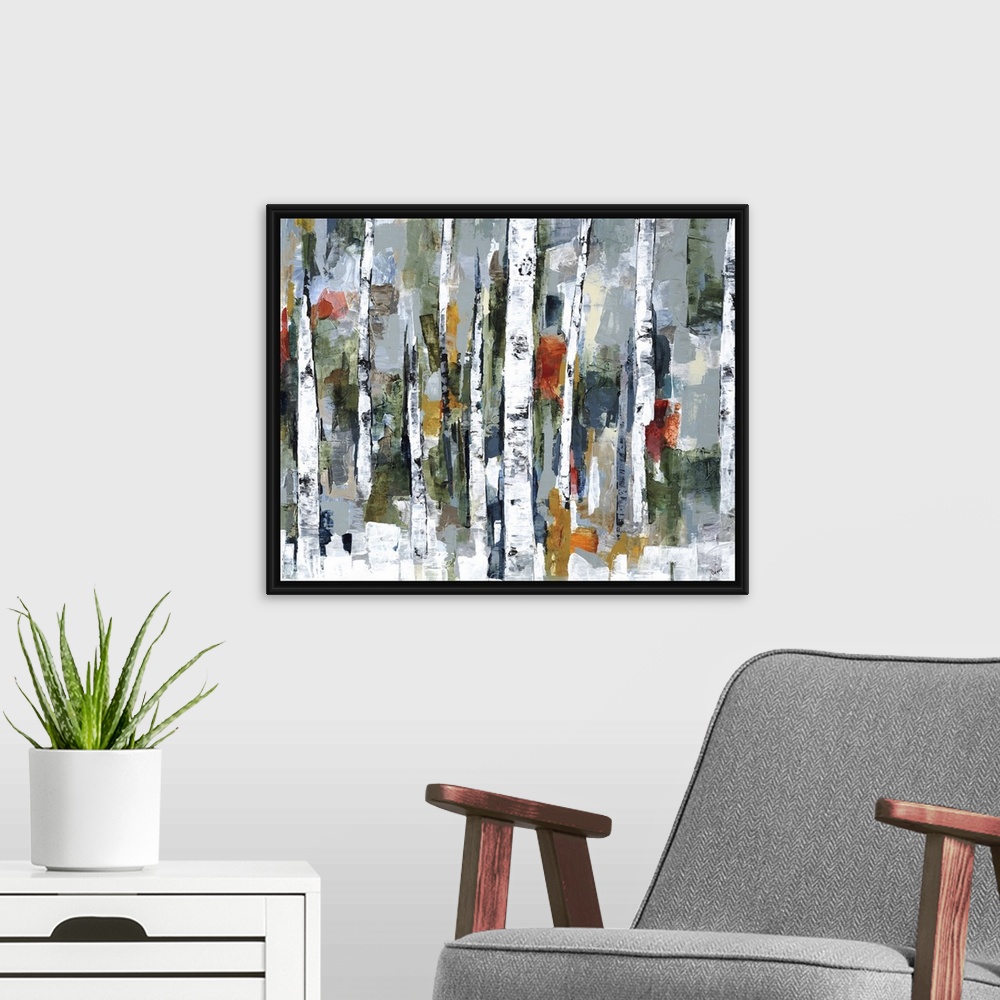 A modern room featuring Large abstract painting of a wooded forest of colorful fall leaves.