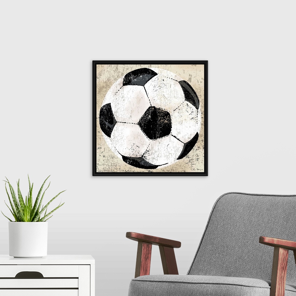 A modern room featuring Vintage style wall art of an old distressed soccer ball on tan and sepia background.