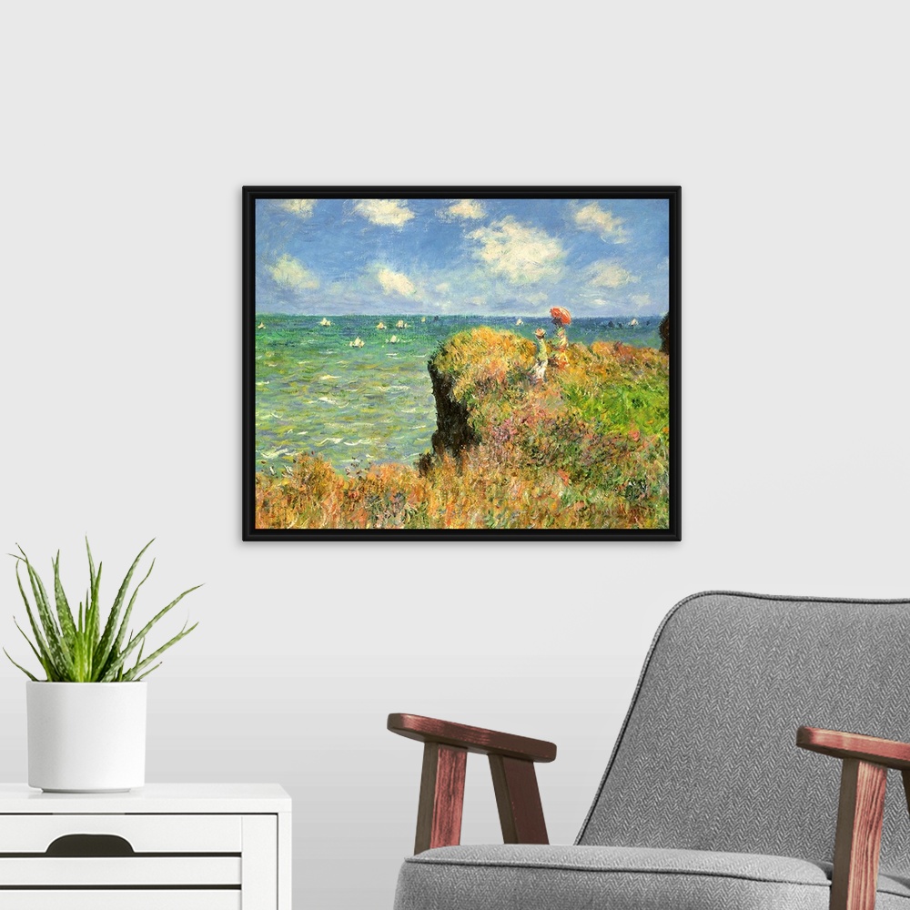 A modern room featuring Painting of people on grassy cliff overlooking ocean full of sailboats under a cloudy sky.