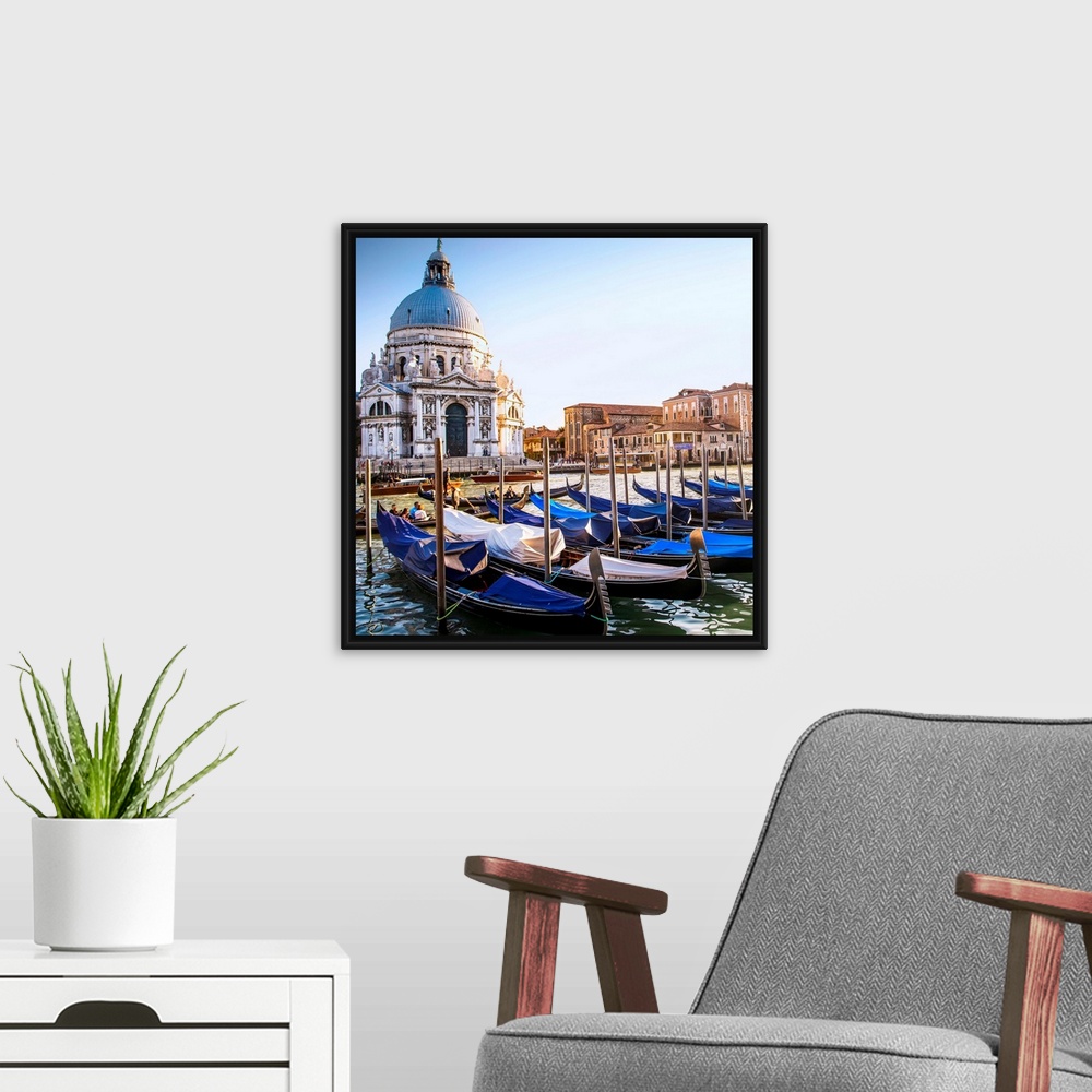 A modern room featuring Square photograph of gondolas lined up in a row in front of Santa Maria della Salute, Venice, Ita...