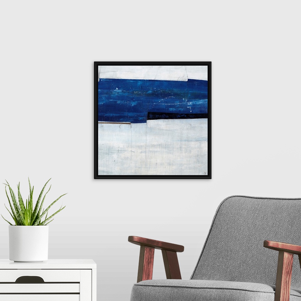 A modern room featuring Abstract painting of a navy blue strip over a cool, gray-blue background.
