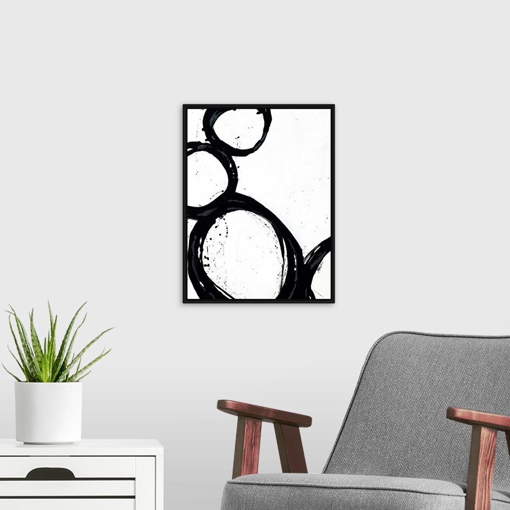 A modern room featuring Large abstract art includes four circles with thick borders as they sit against and on top of eac...
