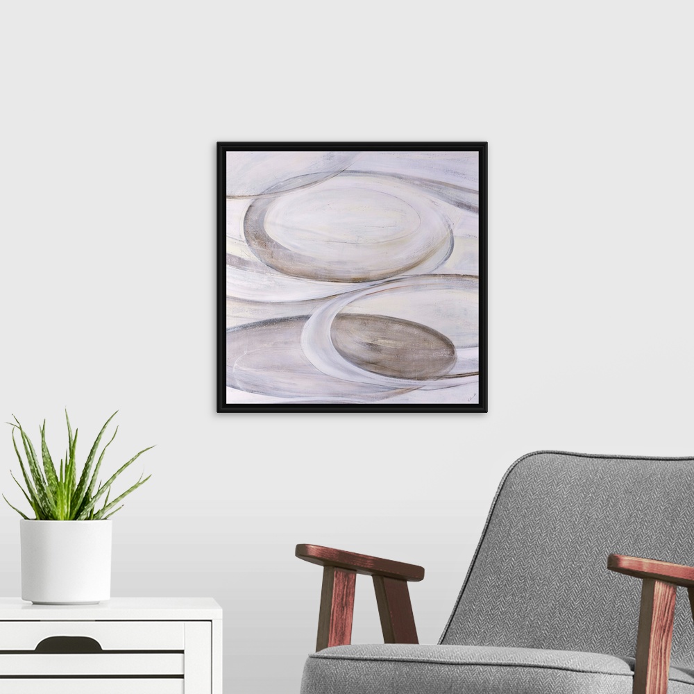 A modern room featuring Monochromatic abstract art of ovular shapes in various shades of cream.