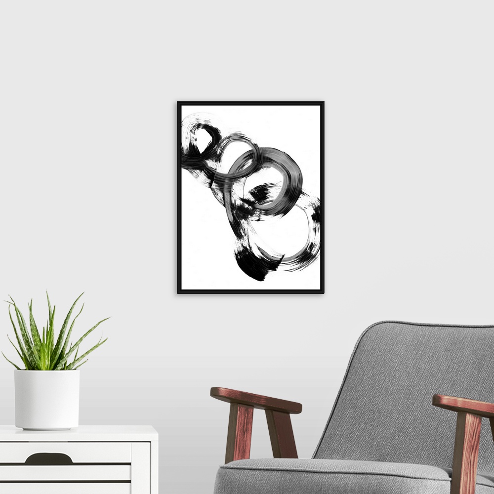 A modern room featuring Contemporary abstract painting of interlocking circular shapes in black and white.