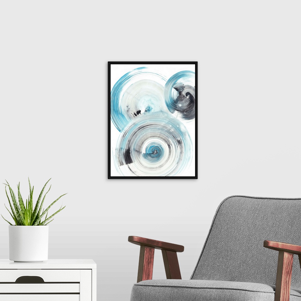 A modern room featuring Contemporary abstract painting of circular forms in blue and black reminiscent of the ripple effe...