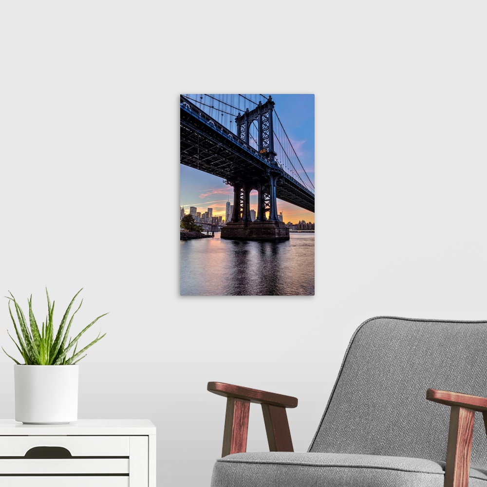 A modern room featuring Manhattan Bridge and NYC skyline at sunset, Brooklyn Bridge Park; Brooklyn, New York, United Stat...