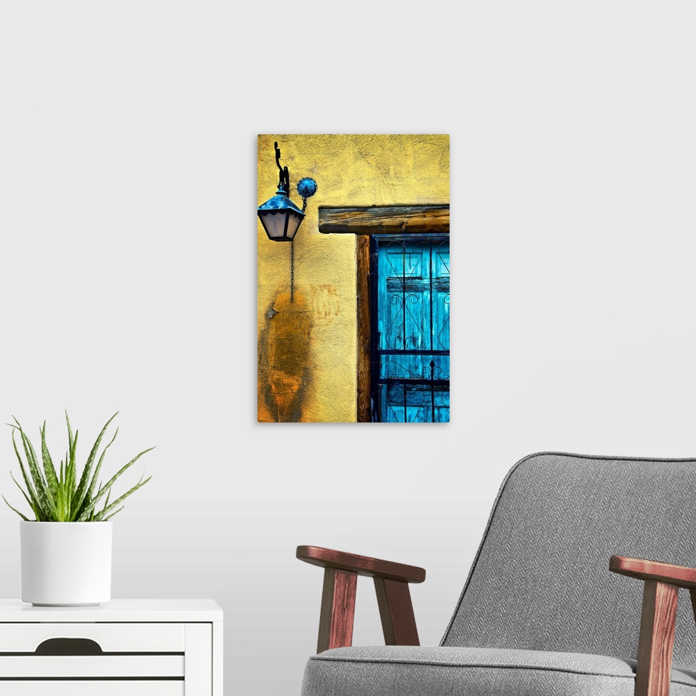 A modern room featuring Vertical panoramic photograph of bright colorful door on stone wall.