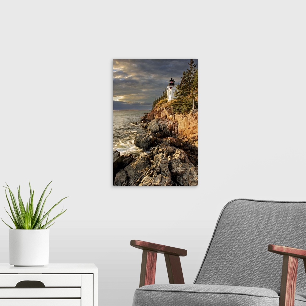A modern room featuring A photograph of a lighthouse on a rocky escarpment on the coastline.